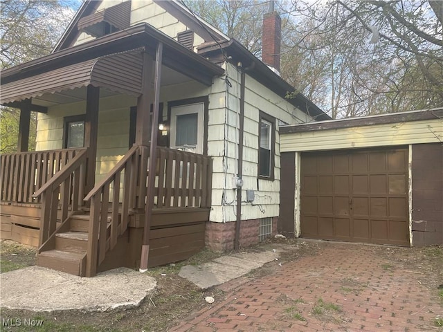 847 Sherman St, Akron, OH 44311 - view of side of home featuring decorative driveway and a chimney
