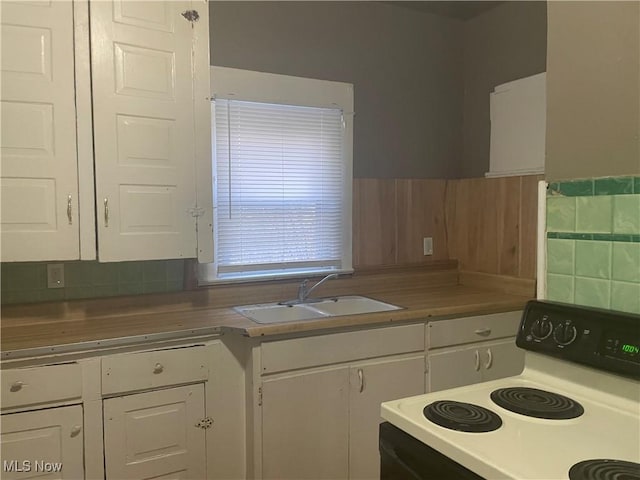 847 Sherman St, Akron, OH 44311 - kitchen with a sink, white cabinets, electric range, and light countertops