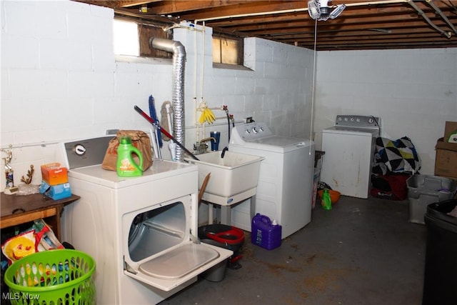 laundry area featuring washing machine and dryer and sink