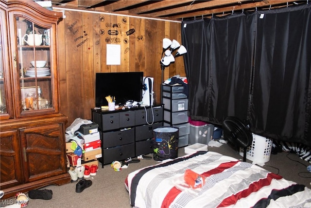 bedroom featuring carpet floors and wooden walls