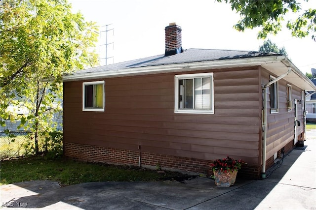 view of side of home with a patio area