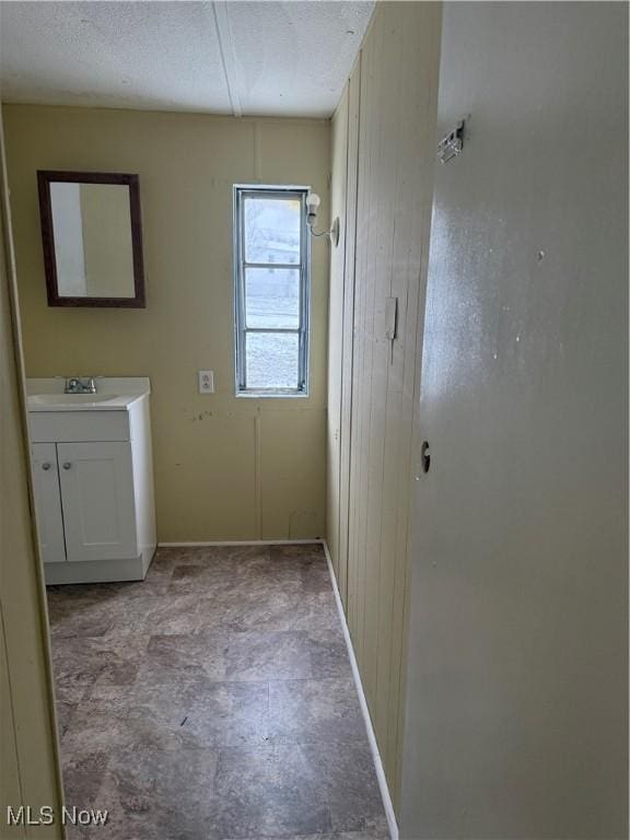 interior space featuring sink and a textured ceiling