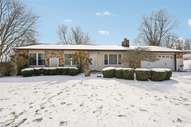 ranch-style home with brick siding, a chimney, and an attached garage