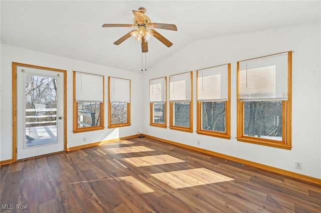 spare room with visible vents, baseboards, lofted ceiling, dark wood-style floors, and ceiling fan