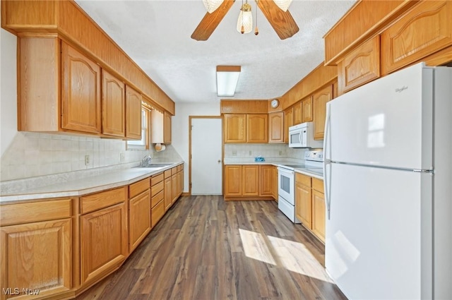 kitchen with white appliances, dark wood-type flooring, a sink, light countertops, and backsplash