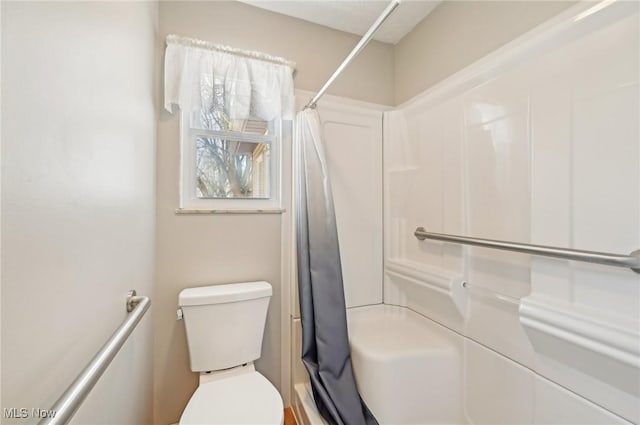 bathroom with curtained shower and toilet
