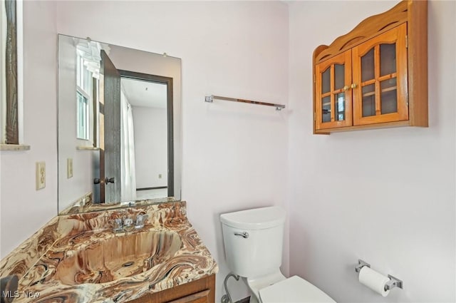 bathroom featuring toilet and vanity