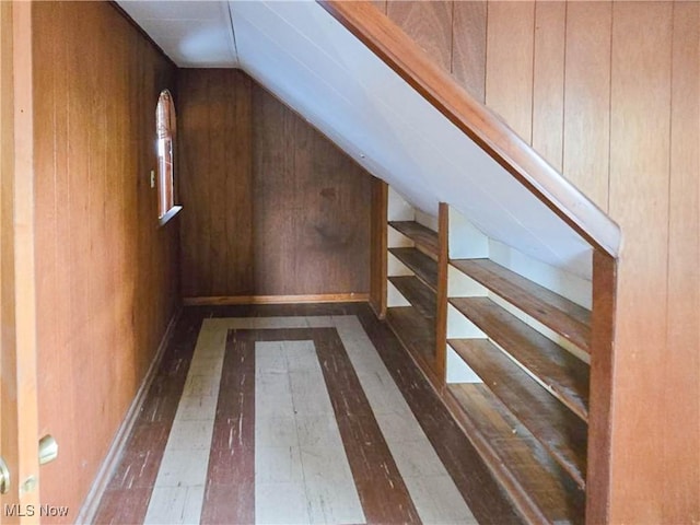 bonus room featuring hardwood / wood-style flooring, vaulted ceiling, and wooden walls