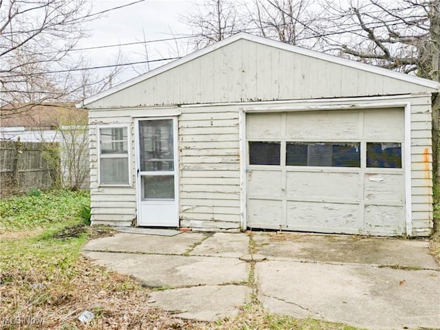 detached garage with driveway and fence