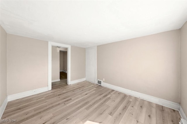 unfurnished room with light hardwood / wood-style floors