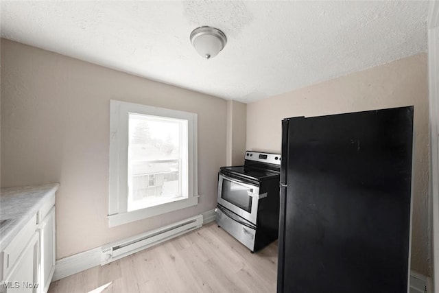 kitchen featuring light wood-type flooring, electric stove, a baseboard radiator, white cabinets, and black fridge