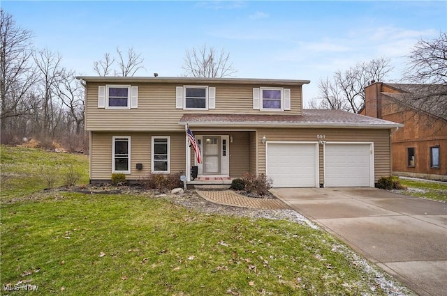 view of front of home featuring a garage, concrete driveway, and a front yard