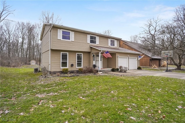 view of front of home with a front lawn, central AC, and a garage