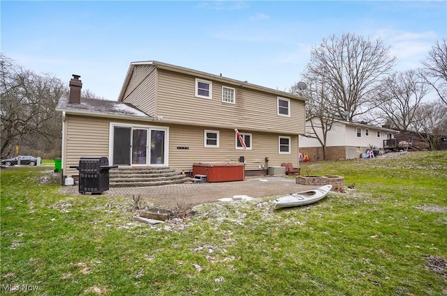 back of property featuring a yard, a patio area, a hot tub, and central air condition unit