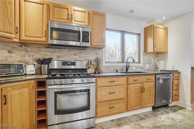 kitchen featuring sink, stainless steel appliances, and tasteful backsplash