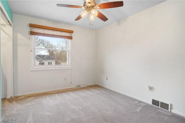 carpeted empty room featuring ceiling fan