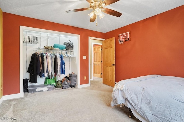 bedroom with light carpet, a closet, and ceiling fan