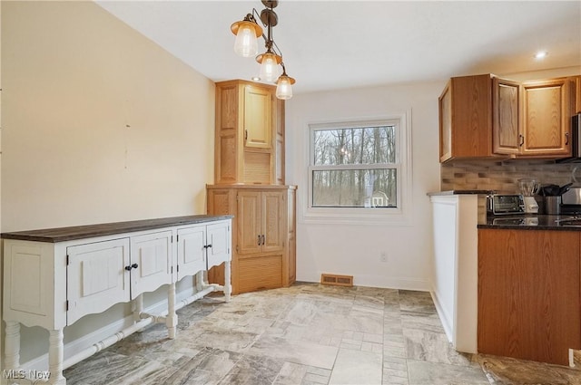 kitchen featuring decorative backsplash and pendant lighting