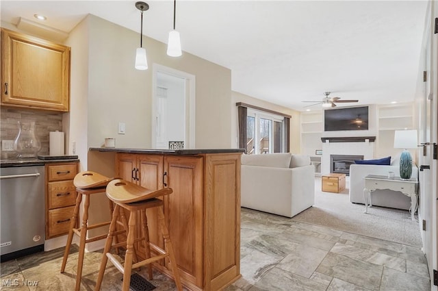 interior space featuring tasteful backsplash, hanging light fixtures, ceiling fan, and dishwasher