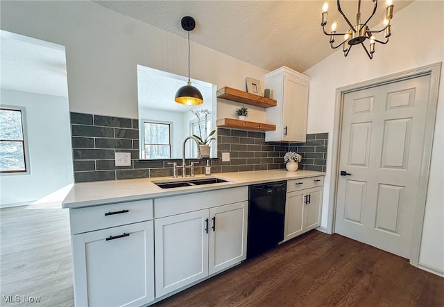 kitchen with white cabinetry, black dishwasher, sink, dark wood-type flooring, and pendant lighting