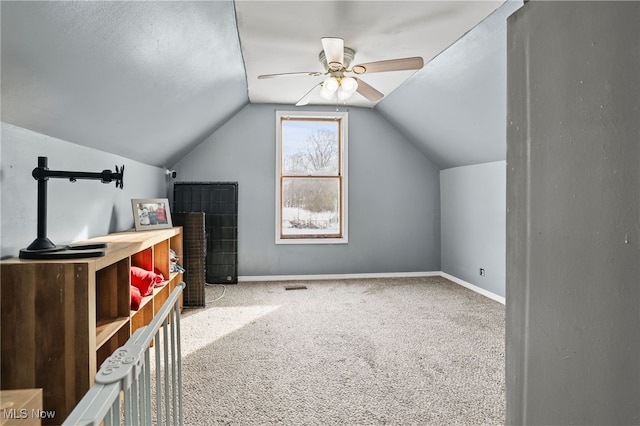 additional living space featuring carpet, vaulted ceiling, and ceiling fan