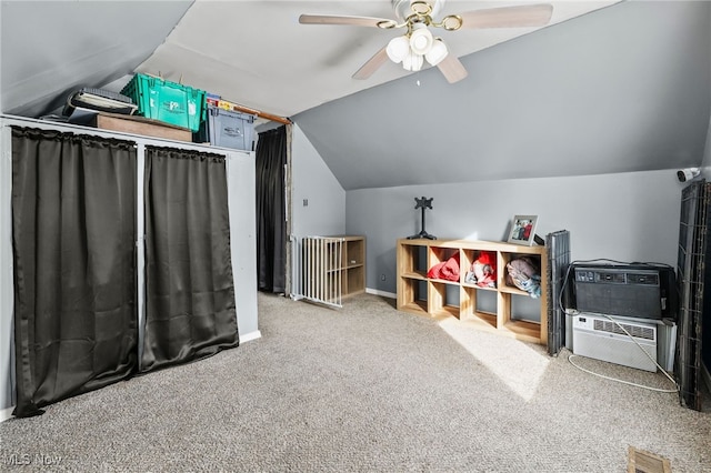 recreation room with ceiling fan, vaulted ceiling, and light colored carpet