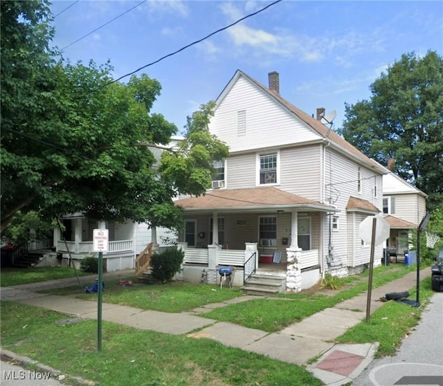 view of front facade with a front lawn and a porch