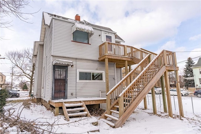 snow covered property featuring a deck