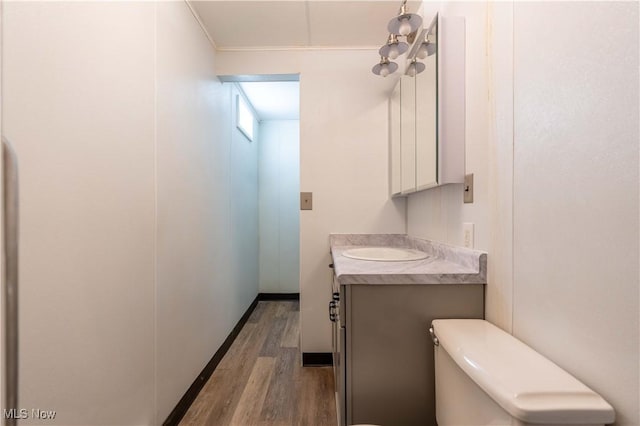 bathroom featuring vanity, toilet, and hardwood / wood-style floors