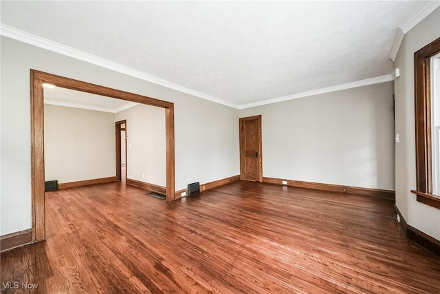 spare room featuring ornamental molding and hardwood / wood-style floors