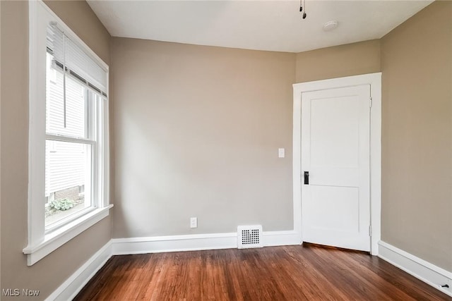 empty room with dark wood-type flooring