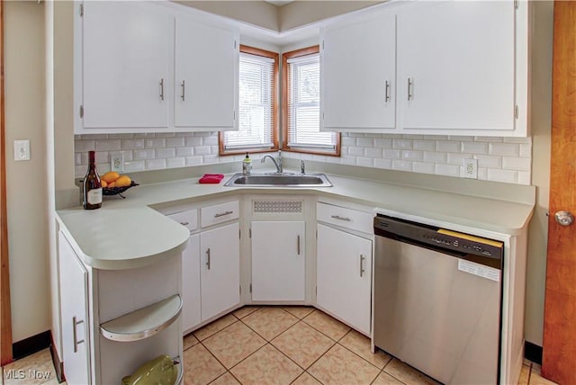 kitchen with a sink, white cabinetry, light countertops, backsplash, and dishwasher