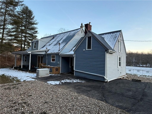 back house at dusk with covered porch