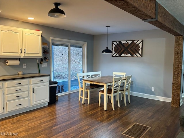 dining area with dark hardwood / wood-style floors