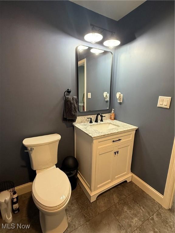 bathroom featuring toilet and vanity