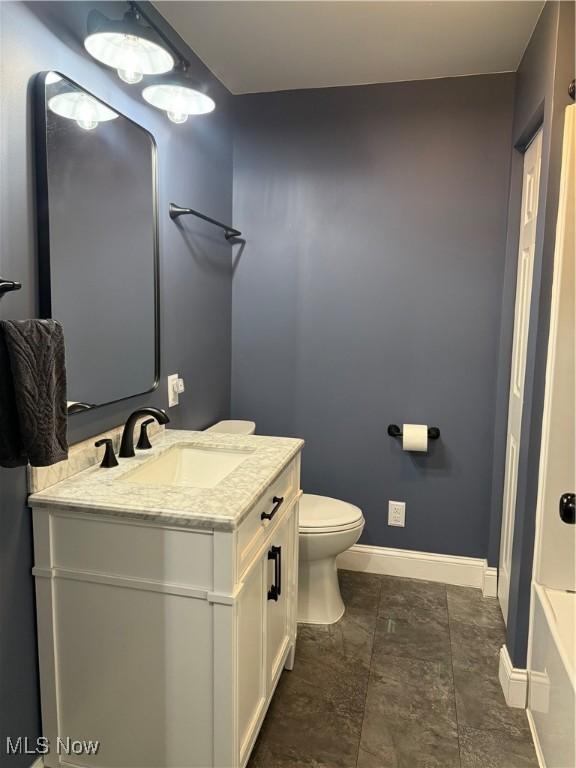 bathroom with toilet and vanity