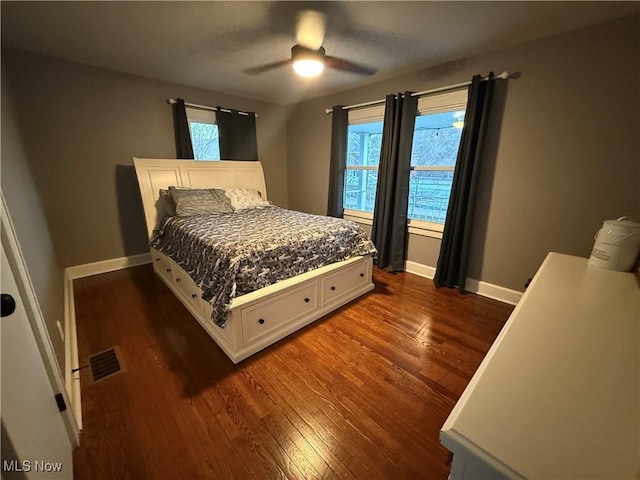 bedroom with ceiling fan and dark hardwood / wood-style flooring