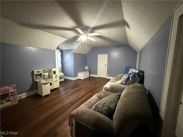 interior space featuring a textured ceiling, lofted ceiling, dark hardwood / wood-style floors, and ceiling fan