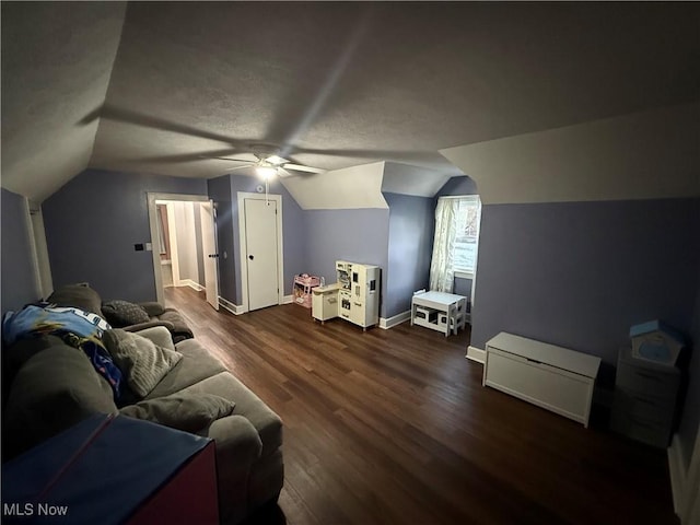 interior space with dark wood-type flooring, vaulted ceiling, and ceiling fan