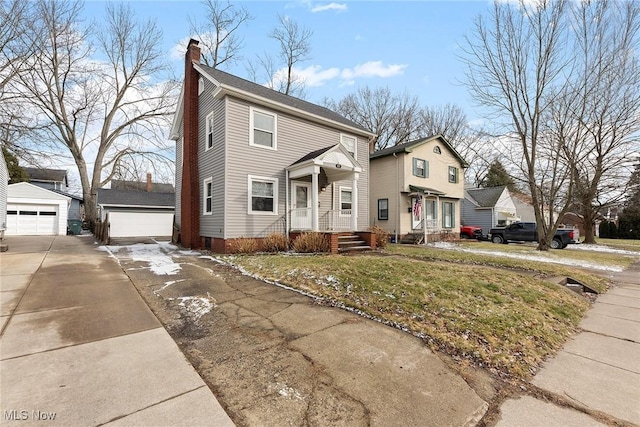 view of front property featuring a garage and an outbuilding