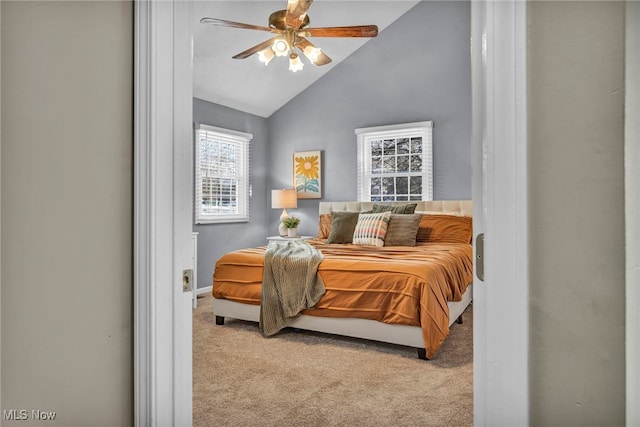 bedroom with lofted ceiling, ceiling fan, and light colored carpet