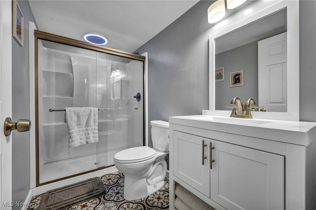 bathroom featuring toilet, vanity, and an enclosed shower