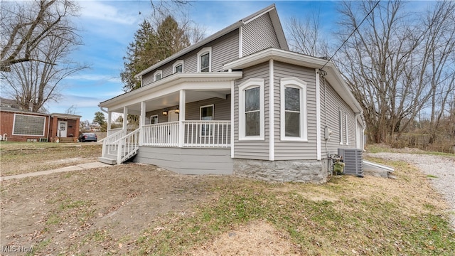 view of front of property with covered porch and central AC unit