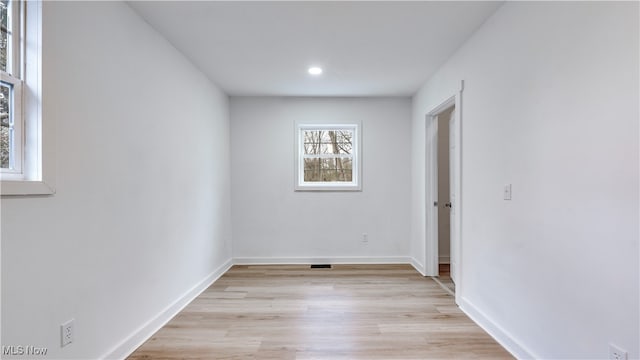 empty room with light hardwood / wood-style flooring