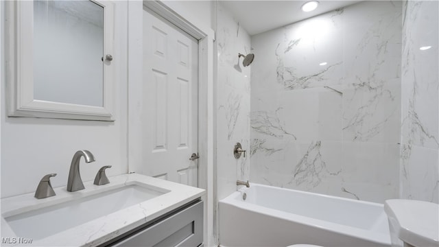 full bathroom with vanity, toilet, and tiled shower / bath