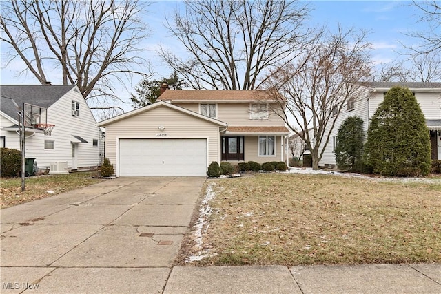 traditional home with driveway, a garage, a chimney, and a front yard