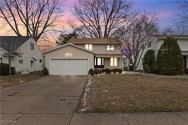 traditional home featuring central AC unit, a chimney, concrete driveway, and a garage