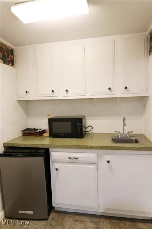 102 Chippewa Dr, Marietta, OH 45750 - kitchen with white cabinets, refrigerator, and sink