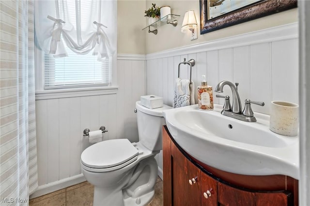 bathroom with vanity, toilet, and tile patterned floors