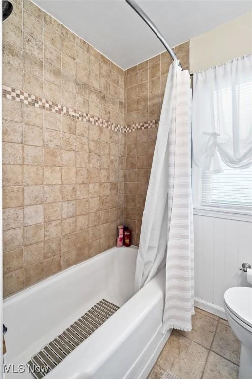 bathroom with shower / tub combo and toilet